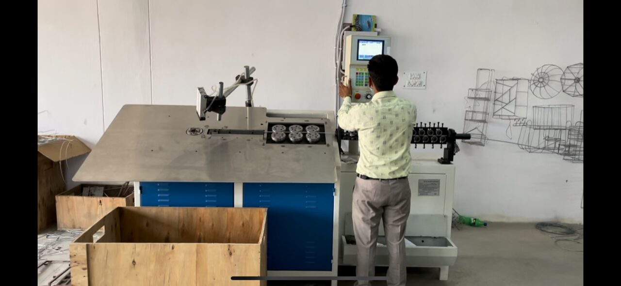 Craftsman assembling components at a Sai Creation workbench